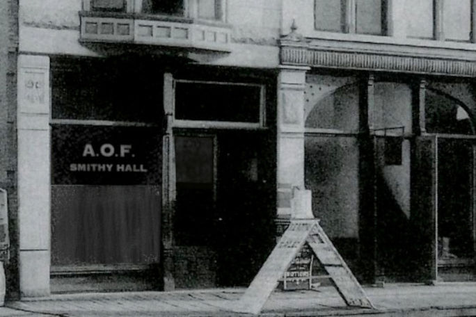 A shop window with the sign A.O.F. Smithy Hall